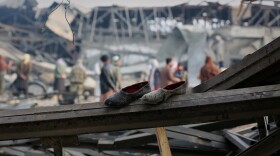 FILE - Residents and rescue workers inspect the site of an airstrike at a drug rehabilitation hospital in Kabul, Afghanistan, March 17, 2026.