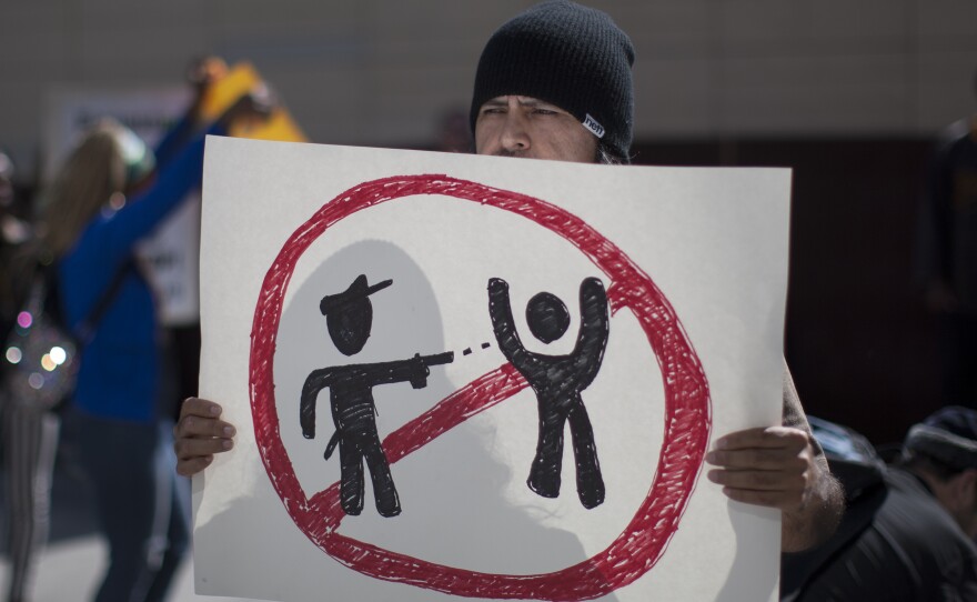 Protesters gather in front of the Los Angeles Police Department Headquarters Tuesday, to express anger over the fatal shooting of an unarmed homeless man Sunday.