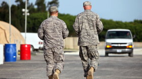 U.S. troops walk the grounds of the Camp Justice compound, the site of the U.S. war crimes tribunal, at Guantanamo Bay, Cuba, in 2009. A bipartisan group of nine senators has proposed legislation that would require accused Sept. 11 terrorists to be tried in military courts.
