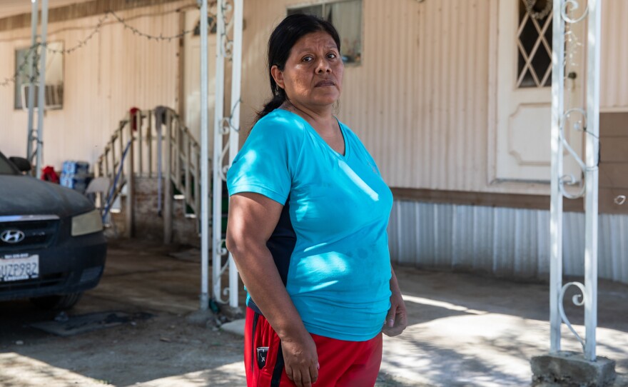 Maria Teresa Zacarias stands in front of her home at Oasis Mobile Home Park in Coachella Valley on Aug. 28, 2023.