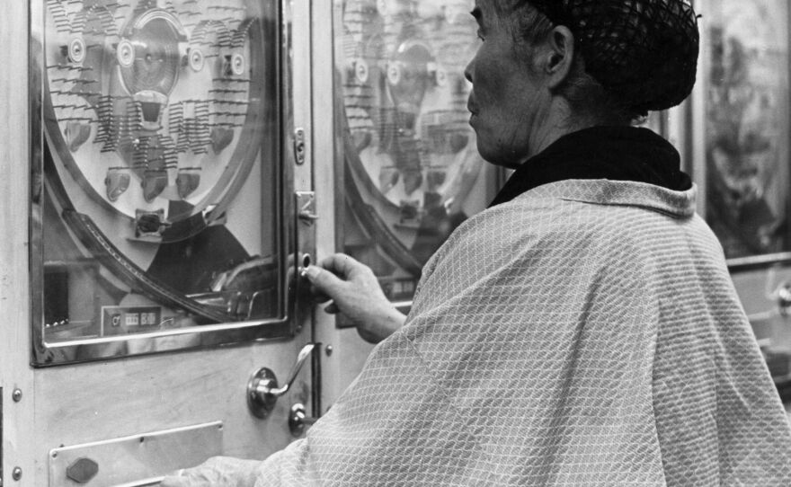 A woman gambles in a Japanese pachinko parlor circa 1955.