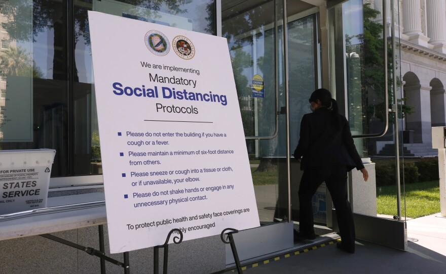 A sign outside the California state capitol advising people of social distancing protocols in Sacramento, Calif. May 4, 2020.