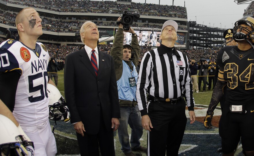 Vice President Biden waits for the coin to drop at an NCAA college football game. He presumably will not flip a coin if he has to break a Senate tie to confirm Loretta Lynch as attorney general.