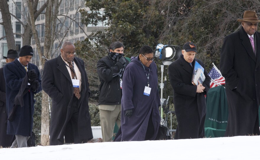 Alexandria, Va., Mayor Bill Euille (third from left); Gary, Ind., Mayor Karen Freeman-Wilson (fifth from left); and other mayors walk toward the White House Thursday for a reception with President Obama and Vice President Biden.