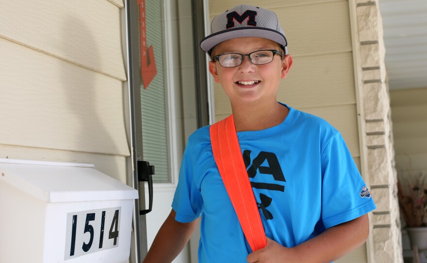 It takes Jaxson Kuhlmann, 11, less than 30 minutes to complete his paper route in Carroll, Iowa. He's paid 10 to 12 cents per copy to deliver the paper five days a week.