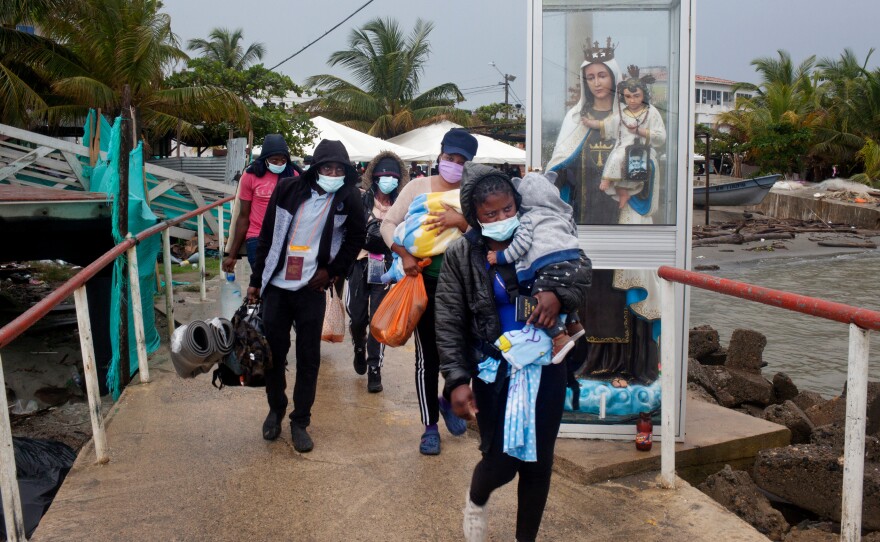 Haitian migrants in Necoclí, Colombia, walk toward boats that will take them to the town of Acandí, across the Gulf of Urabá. The boats can't keep up with the number of Haitians looking to travel from Colombia through the jungle to Panama to eventually reach the U.S.