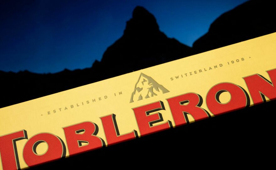 A Toblerone chocolate bar, pictured with the Matterhorn in the background. The company will replace the iconic peak on its label with a more generic mountain as a result of manufacturing changes.