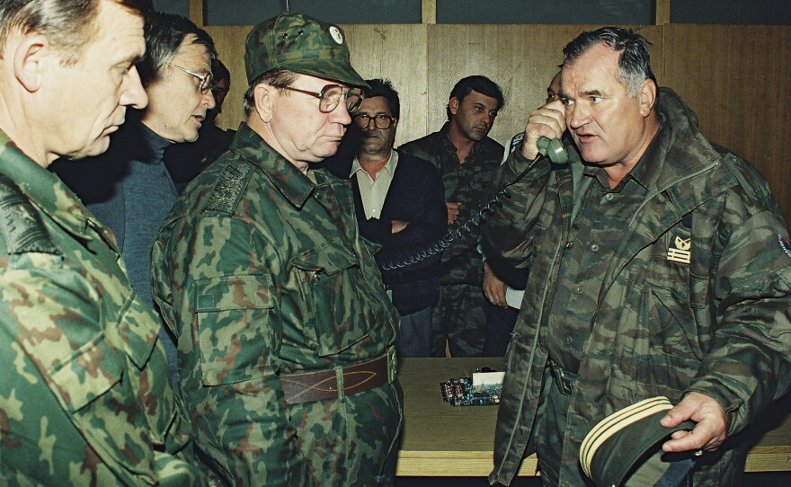 Bosnian Serb Gen. Ratko Mladic (right) talks on the phone next to Russian Army Gen. Vladimir Zurbenko (center) during the visit of a Russian Army delegation to the Bosnian town of Banja Luka in October 1995.