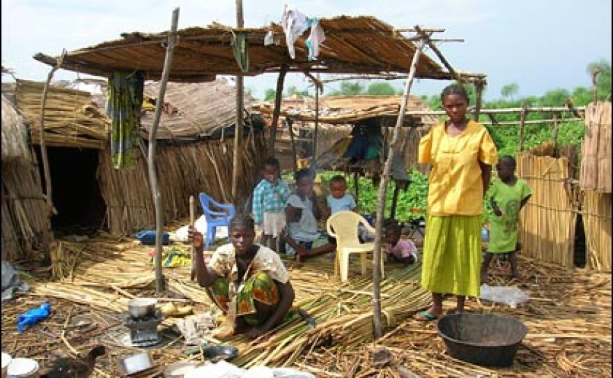 The island of Mitala is extremely muddy.  People lay grass or reed mats on top of the ground to form a place to eat and sleep. Everything on the island is wet. And sticky, black mud gets tracked everywhere.