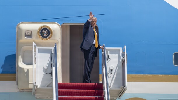 President Donald Trump waves from the doorway of Air Force One at Joint Base Andrews, Maryland, May 12, 2026.