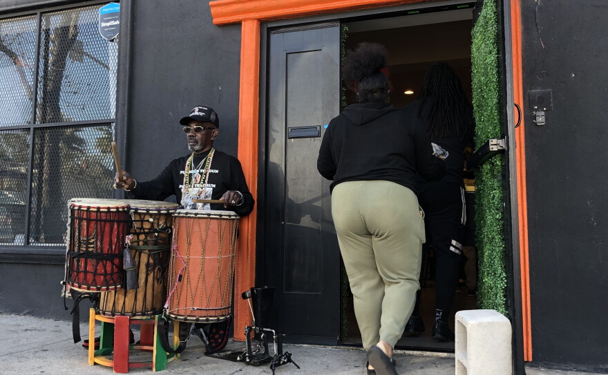A drummer performs outside of Café X: By Any Beans Necessary, Feb. 28, 2022.