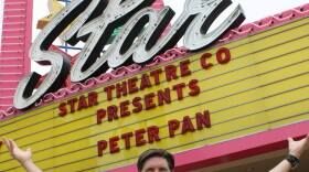 David Schulz, managing artistic director for Star Theatre Company, is pictured in front of the theater’s neon sign, July 2, 2015.