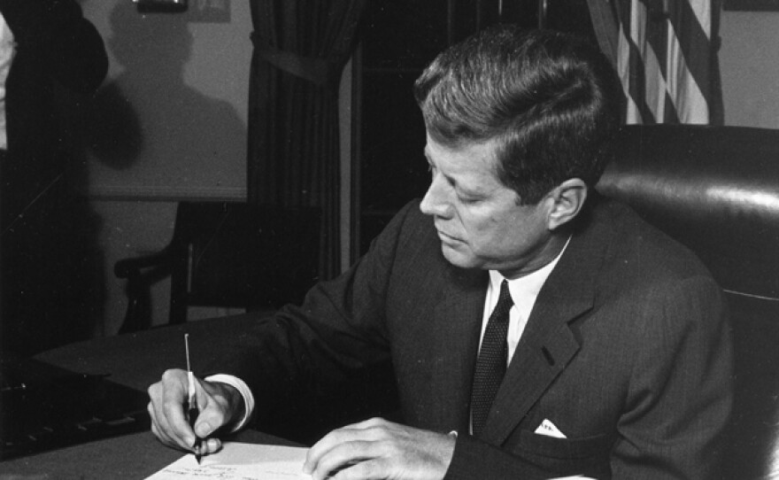President John F. Kennedy signs the quarantine order.
