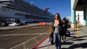 Stranded Carnival cruise ship passengers Jackie Harlan and her family Ryan, 10, and husband Chris are the first passengers to get off the cruise ship at San Diego Harbor on November 11, 2010 in San Diego, California. 