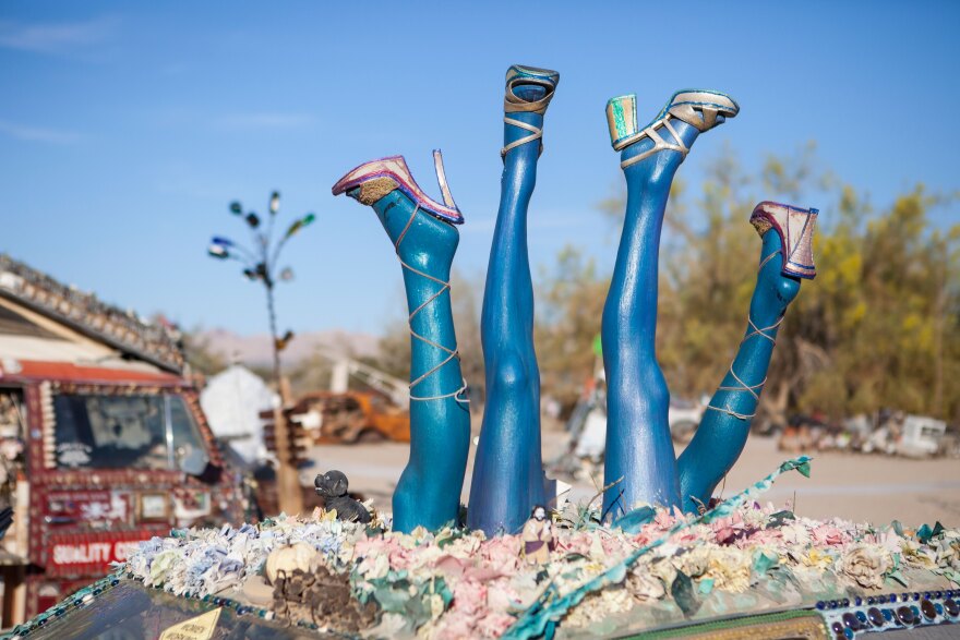 Blue legs top an art car in the sculpture garden at East Jesus, March 28, 2015. 