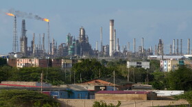 FILE - Flames rise from flare stacks at the Amuay refinery in Los Taques, Venezuela, Jan. 14, 2026.