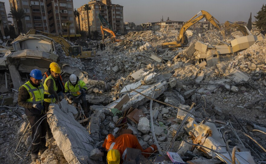 Members of a search and rescue operation work Sunday on an area that collapsed during the earthquake in Antakya, in southeastern Turkey. Disaster recovery experts say ordinary people are crucial to saving lives.