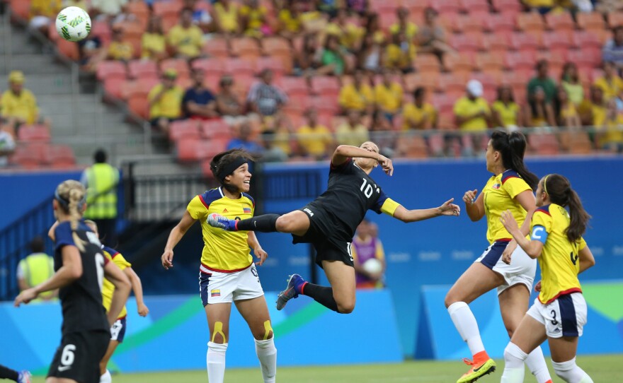 Carli Lloyd of the U.S. (center) jumps for a header during a match with Colombia on Tuesday that ended in a 2-2 draw. The U.S., which won its two previous matches, advanced from its group to the quarterfinals on Friday.