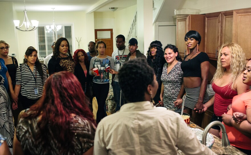 Ruby Corado, foreground left, speaks to her friends and clients before a group dinner on May 5.
