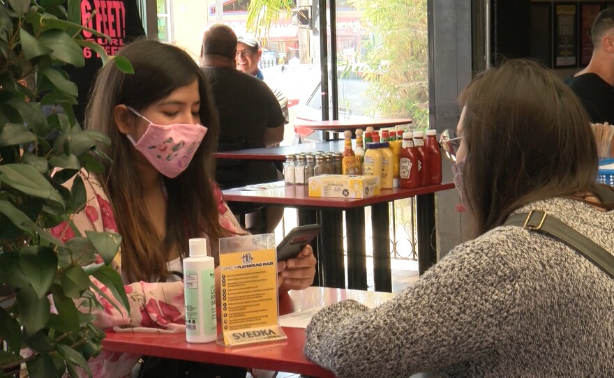 Two women sit down for a socially distanced lunch inside Urban Mo's in Hillcrest, June 19, 2020.