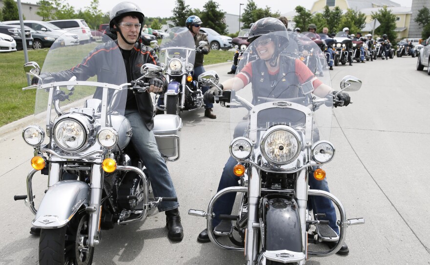 Wisconsin Gov. Scott Walker talks with Sen. Joni Ernst, R-Iowa, before Ernst's Republican fundraising ride Saturday.