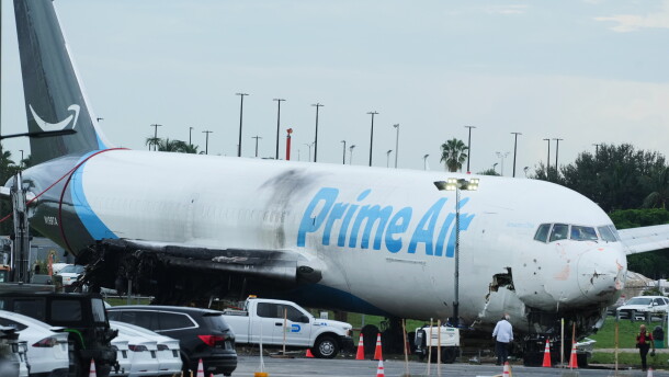 Workers inspect an Amazon cargo plane that overshot a runway four days ago at Miami International Airport, Thursday, Sept. 10, 2026, in Miami.