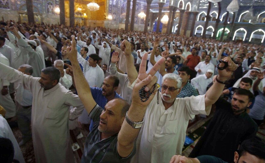 Iraqi Shiites perform the Friday prayer in the shrine city of Karbala in central Iraq. Iraq's top Shiite cleric, Grand Ayatollah Ali al-Sistani, called for the country's next government to be "effective" and avoid past mistakes, in an implicit criticism of Prime Minister Nouri al-Maliki.