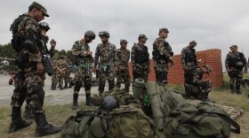 Nepalese army soldiers prepare to leave for a rescue mission to the site where the suspected wreckage of a U.S. Marine helicopter, that disappeared earlier this week while on a relief mission in the earthquake-hit Himalayan nation, was spotted, in Kathmandu, Nepal, May 15, 2015. 