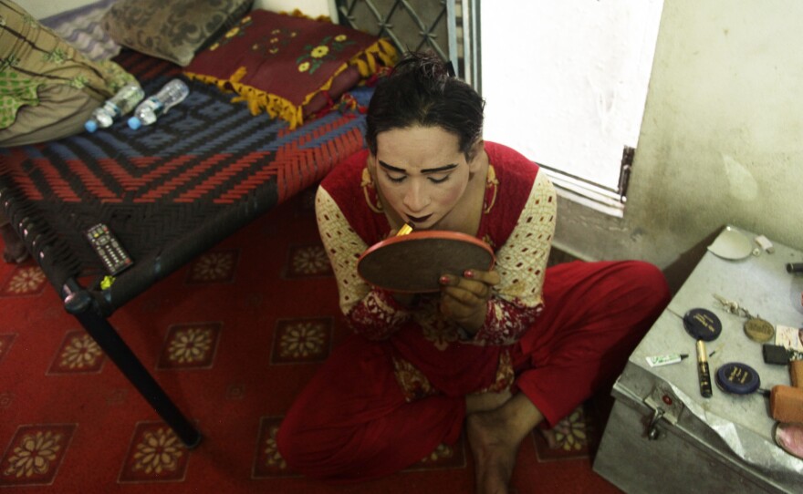 A transgender woman, Shabnam, applies makeup before heading out to beg on Lahore's streets. She was delighted when Pakistan granted transgender people the right to acquire identity cards listing themselves as third gender. She has applied for a card and will use it to open a bank account – and buy tickets to watch cricket.