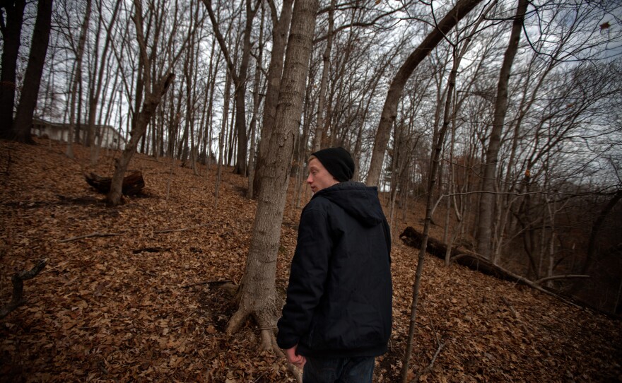 Piper walks in the woods behind his parents' home in Mount Carroll, Ill. He and Pacas were friends, and used to float on inner tubes in the nearby river.