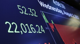 A screen above the floor of the New York Stock Exchange shows the closing number for the Dow Jones industrial average, Wednesday, Aug. 2, 2017. 