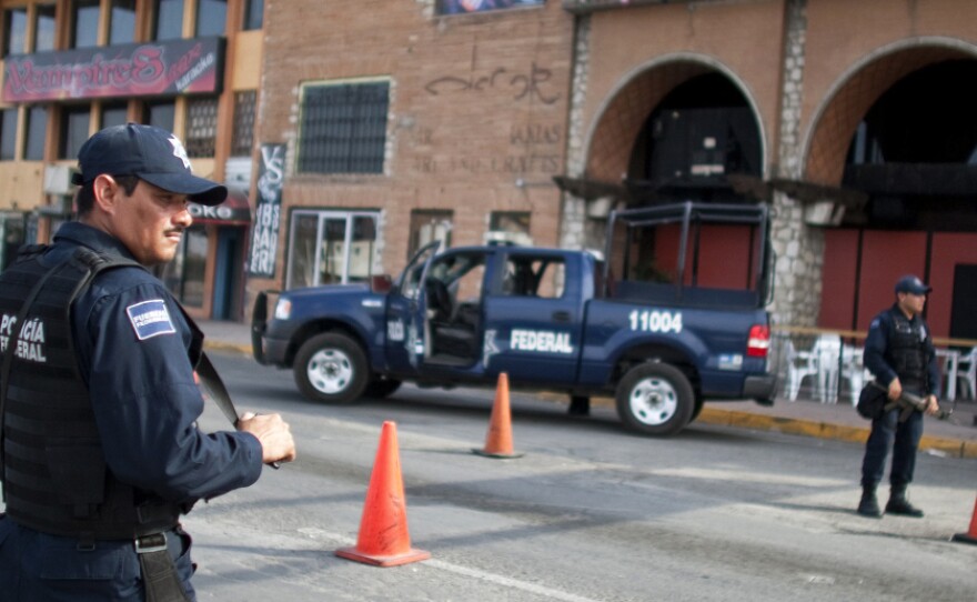 Mexican federal police man a checkpoint in downtown Juarez, Mexico, on July 13. Despite being hard hit by drug violence, Mexican border cities remain attractive to foreign businesses seeking cheap labor and easy access to the U.S.