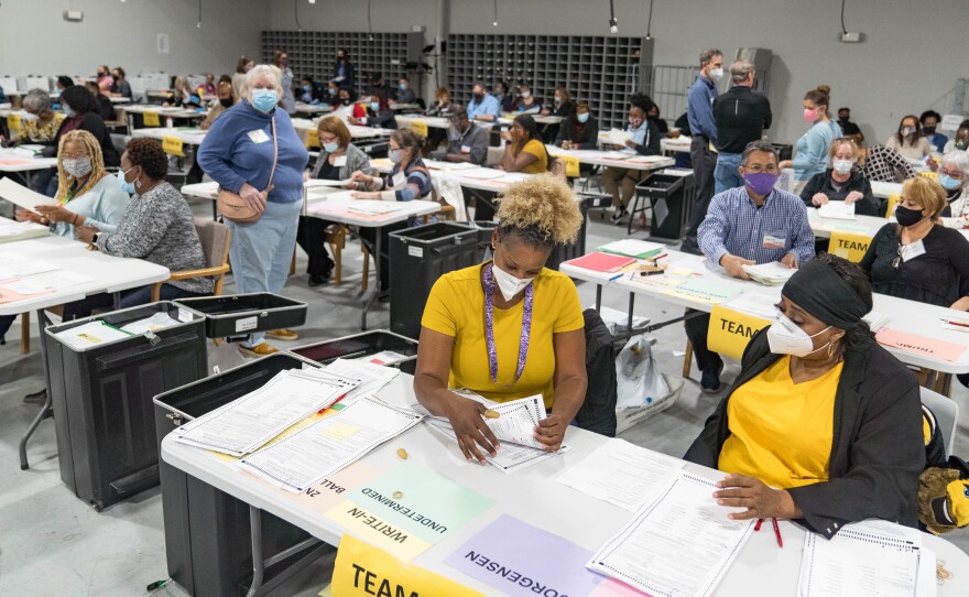 Gwinnett County election workers handle ballots on Nov. 16 as part of the recount for the 2020 presidential election.