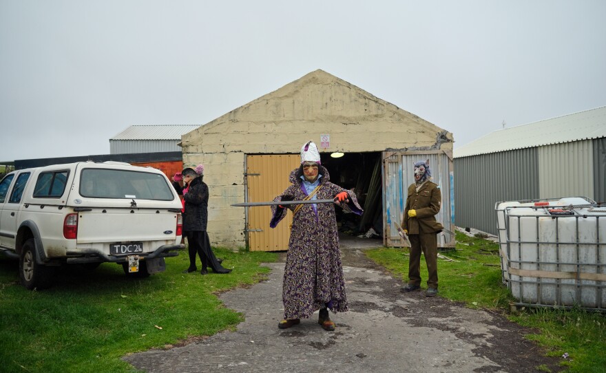 An Okalolie dressed as King Charles III walks out of their clandestine changing room. In honor of the king's coronation last year — Tristan da Cunha is a British overseas territory — two participants transformed themselves into the king and queen.