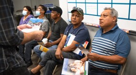 North county residents are handed election materials by Paul Mendoza, a candidate for the Vallecitos Water District, at the Universidad Popular election education fair in San Marcos, Oct. 20, 2022.