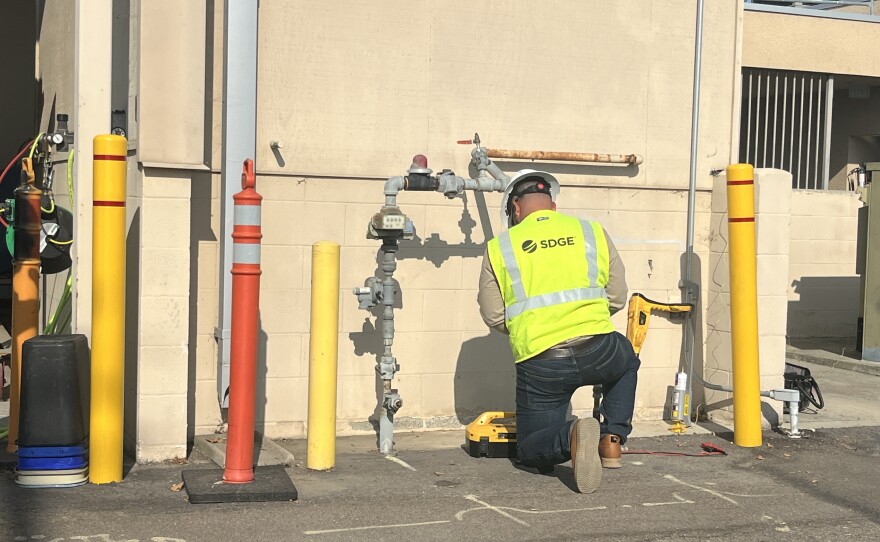 A SDG&amp;E worker demonstrates how to check gas lines, Aug. 11, 2025.