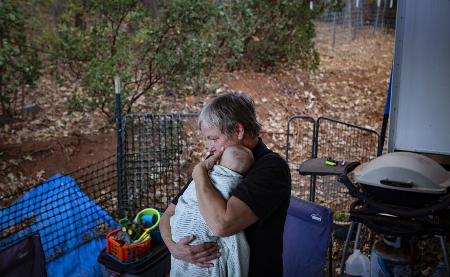 Kim Schwartz holds Bishop. Kim will move into a tract home on a piece of land next to Chelsea and Noah's house. She is excited to have her own place but still be near her four grandchildren, with whom she hopes to arrange monthly individual overnights for quality one-on-one time.