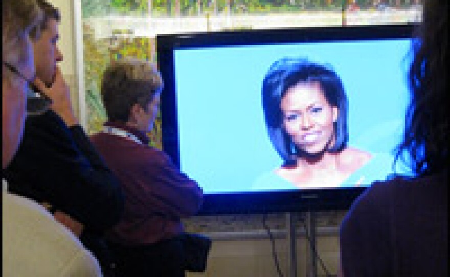 An overflow crowd watches Michelle Obama, wife of Democratic Presidential candidate Barack Obama, address the Democratic National Convention in Denver on August 25, 2008.