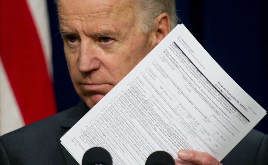 Vice President Joe Biden shows a background check form as he calls on Congress to pass legislation aimed at reducing gun violence at the Eisenhower Executive Office Building in Washington on April 9.