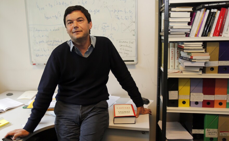 French economist and academic Thomas Piketty, poses in his book-lined office at the French School for Advanced Studies in the Social Sciences (EHESS), in Paris, earlier this month.