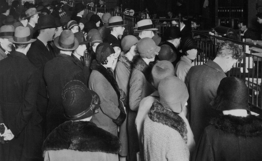 Investors rush to withdraw their savings during a stock market crash, circa 1929.