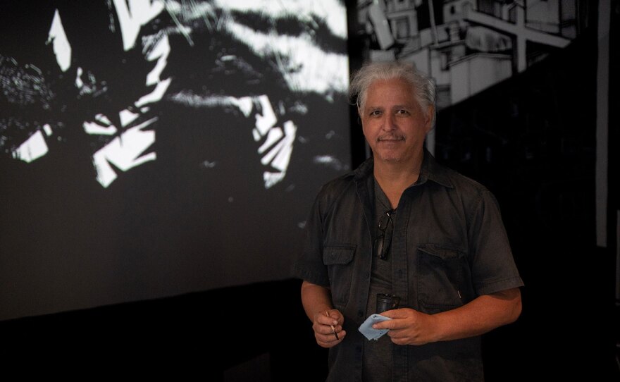 Artist Hugo Crosthwaite is shown in an undated photo working on his installation, "The Rupture of the White Cube," at Mesa College Art Gallery.