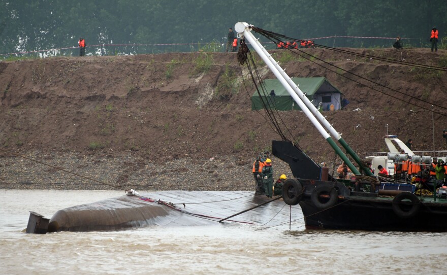 Rescue teams work at the site of the overturned ship in the Jianli section of the Yangtze River in central China's Hubei Province Wednesday.