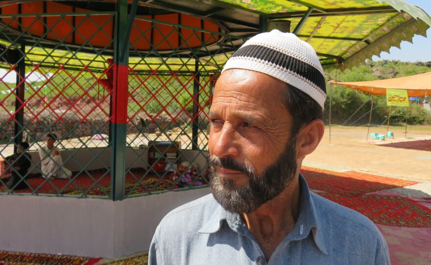 Raja Nafees Ahmed at the grave of his son-in-law, Mumtaz Qadri, near the Pakistan capital of Islamabad. Qadri was a policeman in 2011 when he shot and killed a politician who questioned the country's blasphemy laws. Qadri was hanged last month and his grave has become a shrine for supporters who insist that blasphemy laws not be eased.