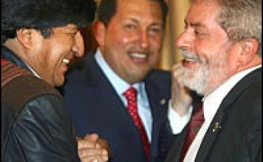 Lula da Silva, right, and his Bolivian counterpart, Evo Morales, shake hands as Venezuela's Hugo Chavez looks on during a meeting in May 2006 to discuss the economic impact of Bolivia's move to nationalize its hydrocarbon industry.