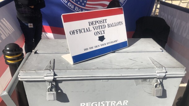 A ballot box is watched by two attendants at the San Diego Registrar of Voters, March 11, 2022.