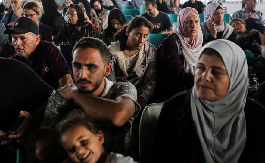 Citizens with foreign passports wait to travel through the Rafah crossing on Thursday. At least 300 civilians, all of them foreign citizens or dual nationals, departed Gaza Wednesday.