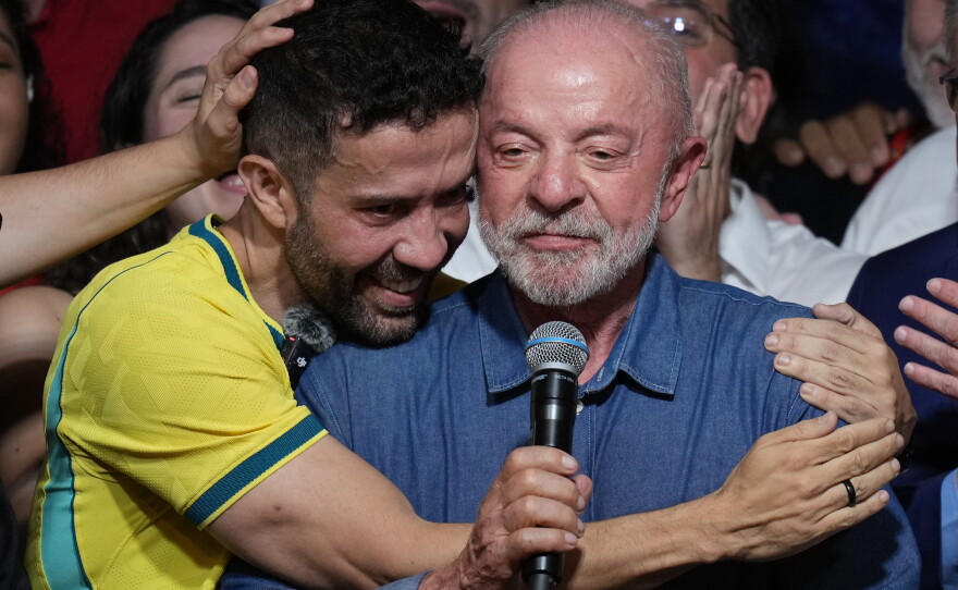 Brazilian lawmaker André Janones embraces President Luiz Inacio Lula da Silva as he delivers a victory speech after winning a fourth term in the presidential runoff in , Brazil, Sunday, Oct. 25, 2026.