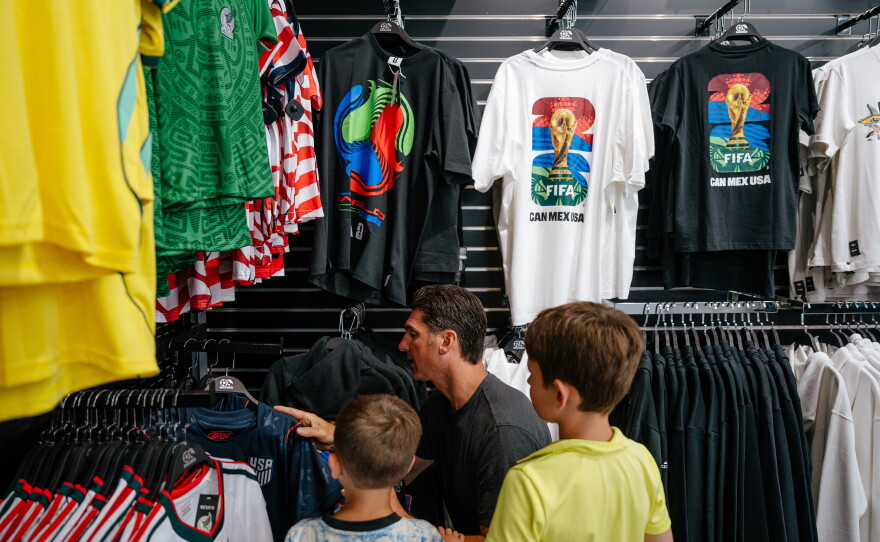 Shopper Matt Abro looks at U.S. Men's National Team jerseys with his sons at Soccer World.