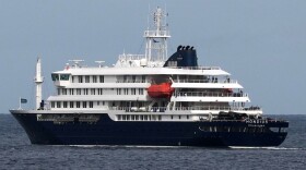 The MV Hondius cruise ship departs the port in Praia, Cape Verde, Wednesday, May 6, 2026.